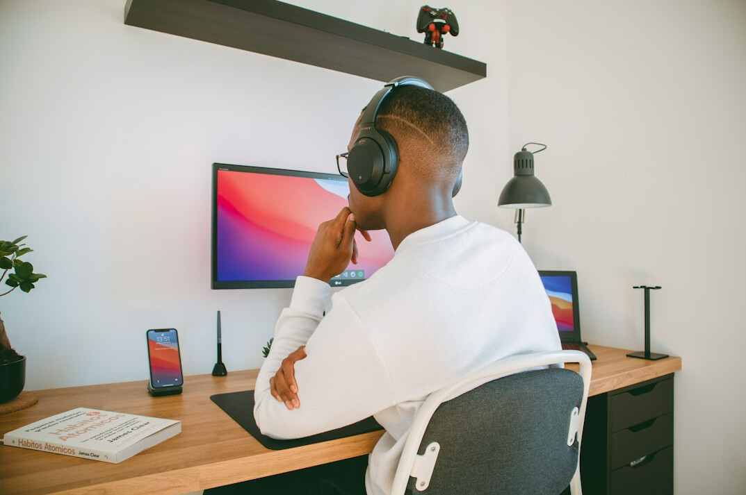 person coding at home desk