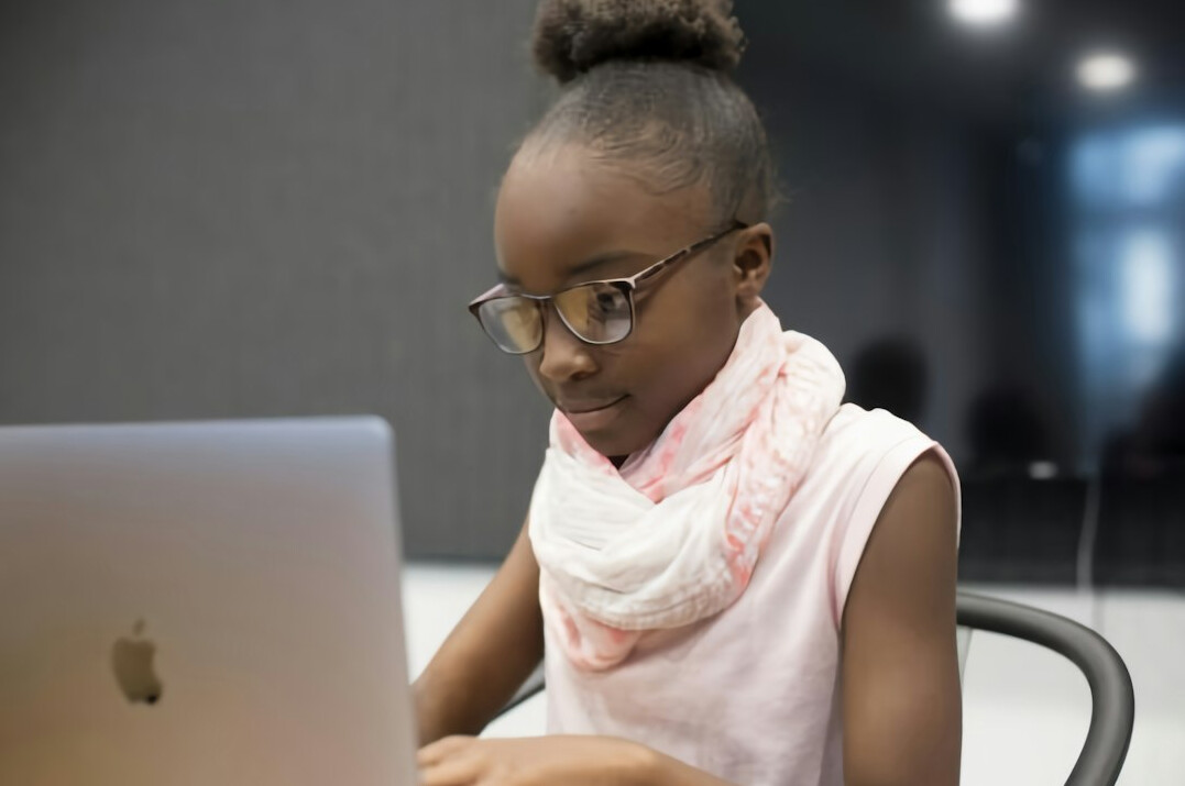 child learning coding on laptop