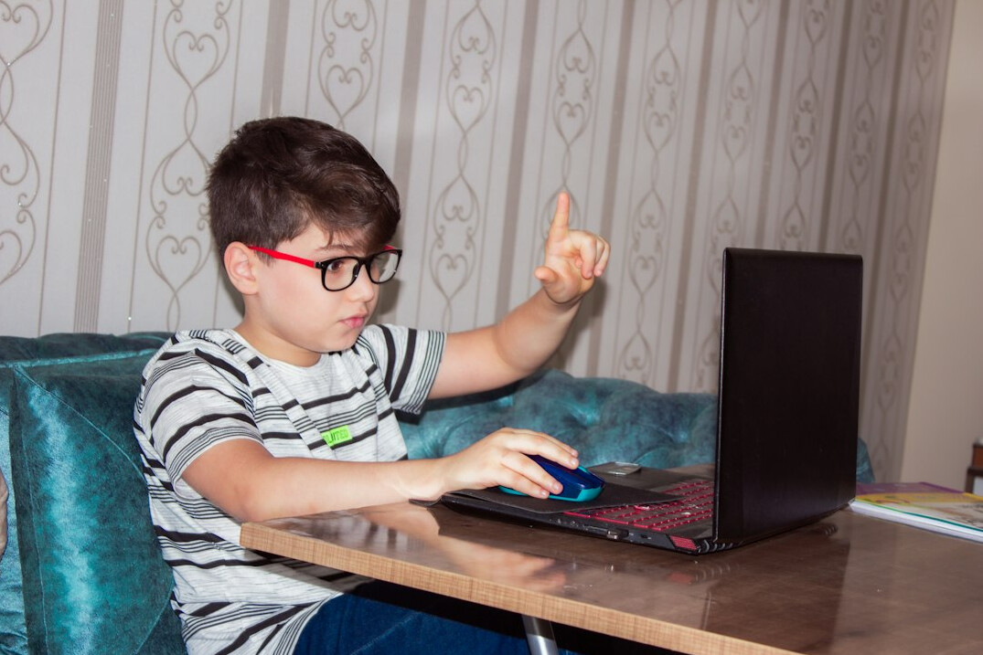 child learning coding on laptop