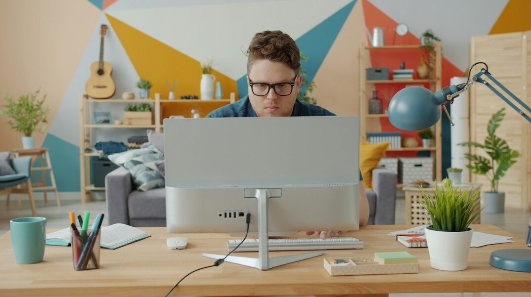 person coding at home desk